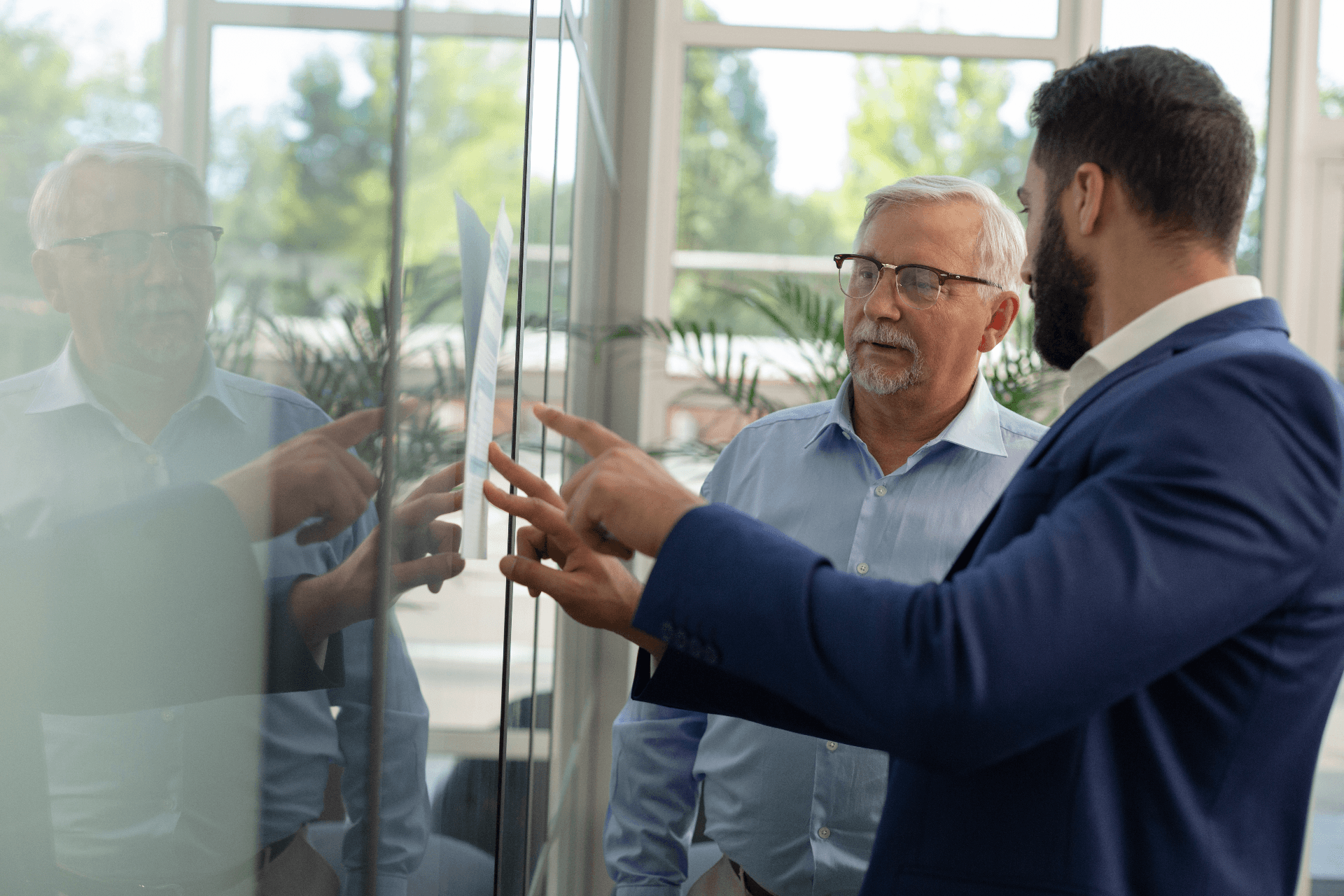 Two professionals collaborating and discussing strategy in modern office setting